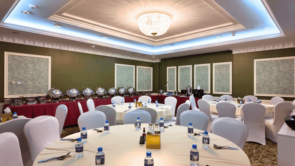 Elegant Coral Room event space with round tables and chairs at Warwick Doha.