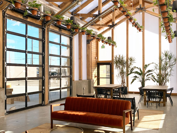 Chairs, tables & plants in The Greenhaus at Kinship Landing