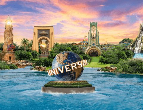 Universal globe on a lagoon with park landmarks and a waterfall at Universal Orlando Resort near Rosen Inn International