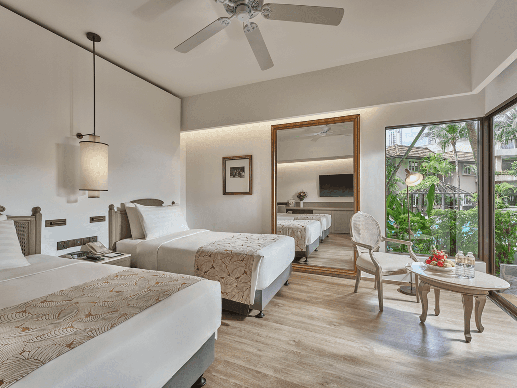 Bedroom area in Deluxe Poolside Room at Goodwood Park Hotel