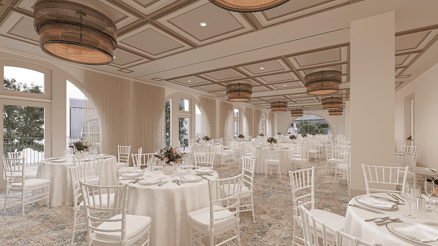 La Terraza Ballroom at El Prado Hotel, prepared for an event with white tables, chairs, and large windows
