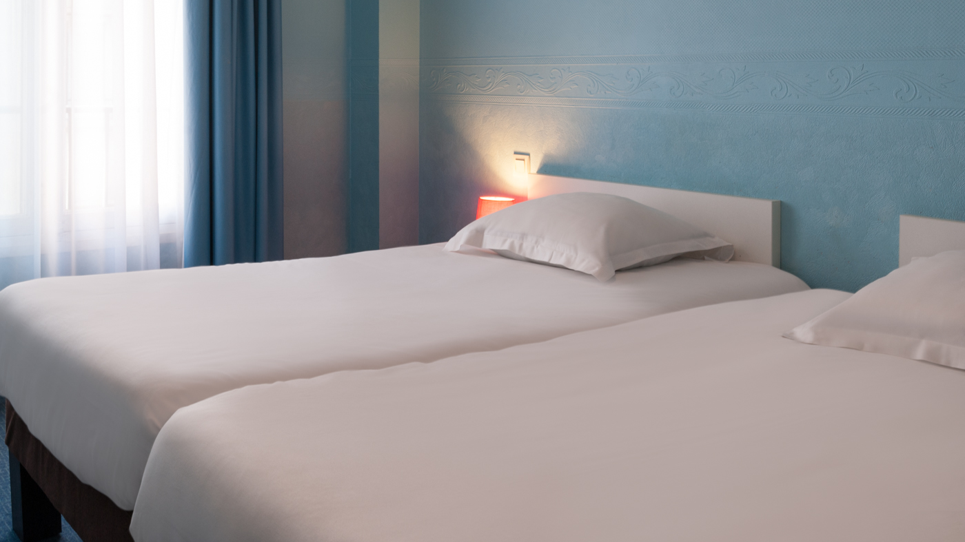 Closeup of twin beds at a bedroom in Originals Hotels