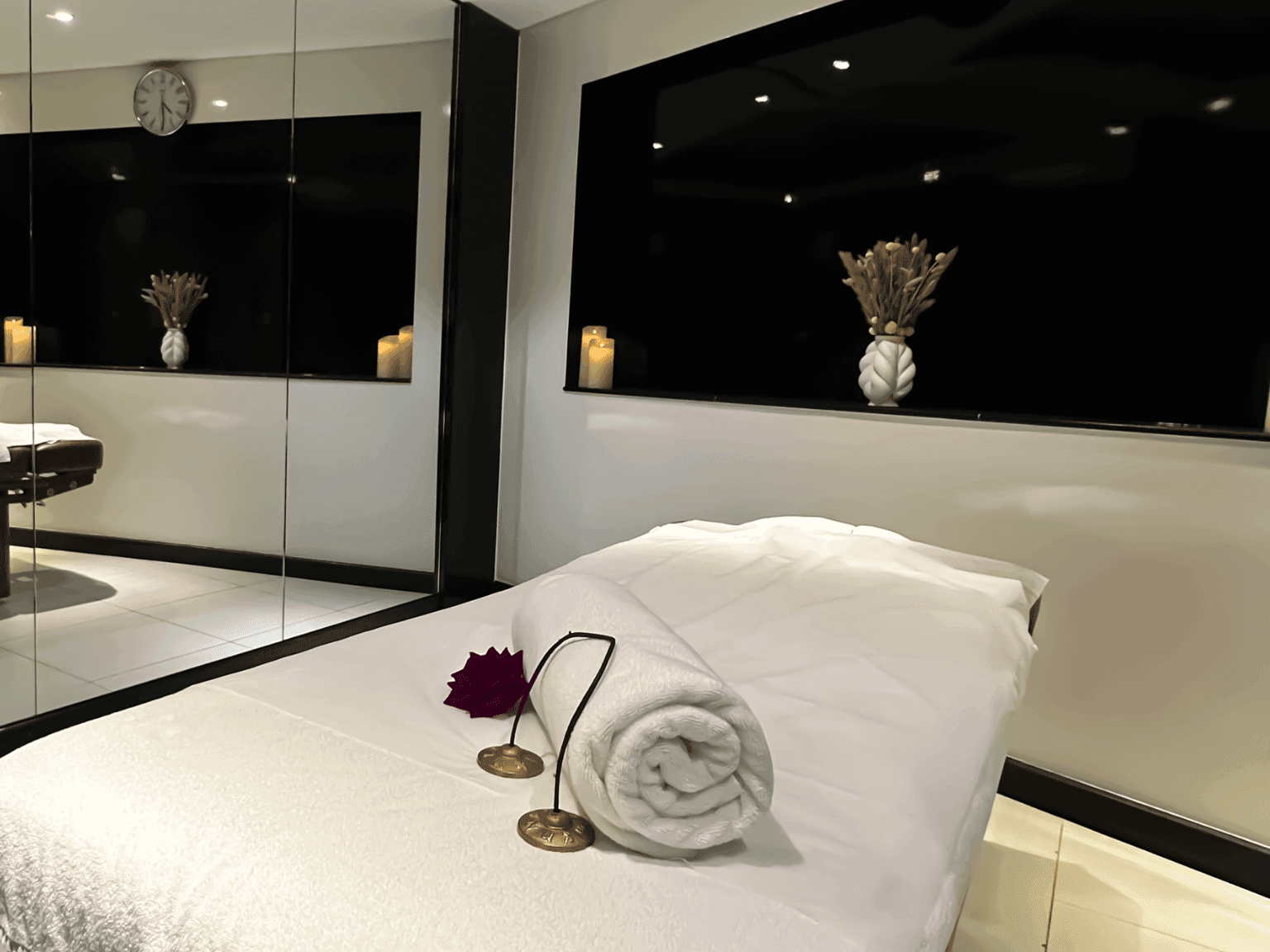 Dreamworks Spa room with candles, rolled towel, and a peaceful setup offering calm retreat at DAMAC Maison Distinction