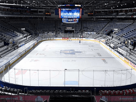Blue seats and a large scoreboard in Coca-Cola Coliseum near Hotel X Toronto