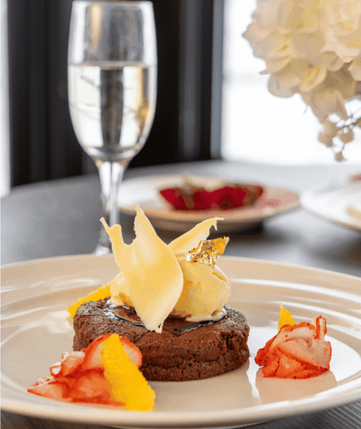 Decadent chocolate dessert topped with vanilla ice cream and fruit garnishes at the restaurant inside Rodd Miramichi 