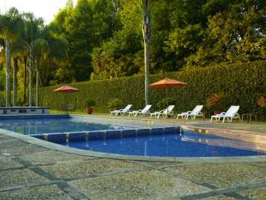 An outdoor swimming pool & sunbeds at Gamma Hotels