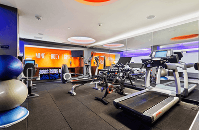 Gym equipment by a mirror at The J House Greenwich, a luxury hotel in Fairfield County for business travelers
