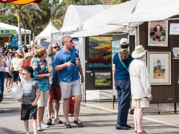 people walking thru coconut walk art festival