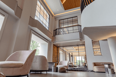 Elegant lounge area with comfy chairs and tables at Amora Hotel