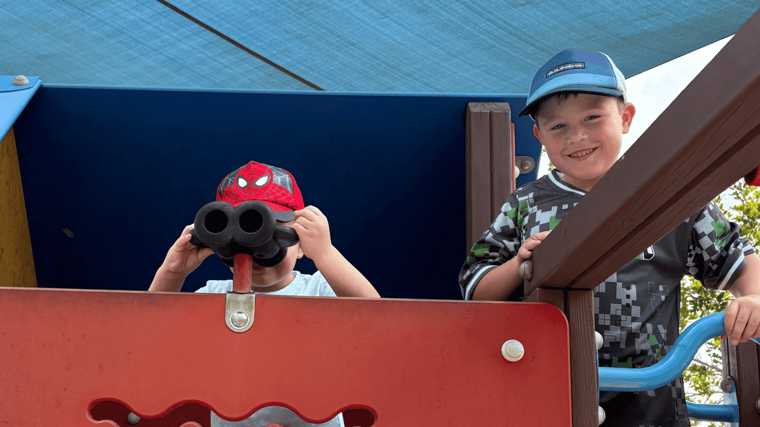 Two boys on a play structure with binoculars at Winter School Holidays Activities.
