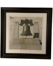 Wall art of a giant bell with black frame at Hotel 43