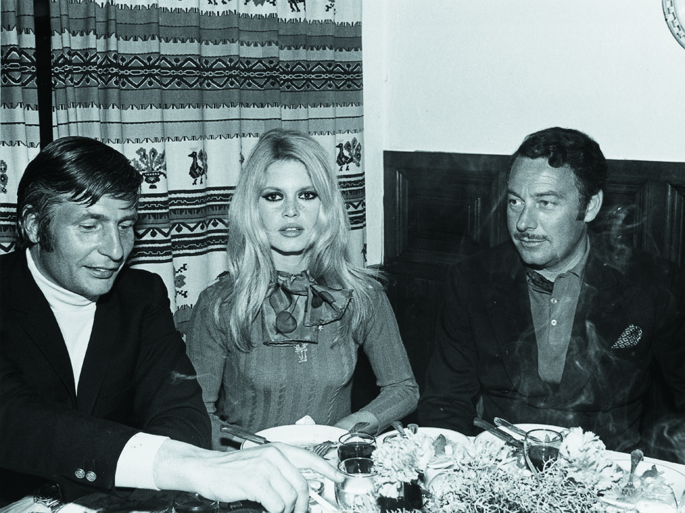 Group of 3 seated at the dining table at Marbella Club in 1960