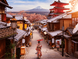 A woman in a kimono strolling down a street near Hop Inn Hotel