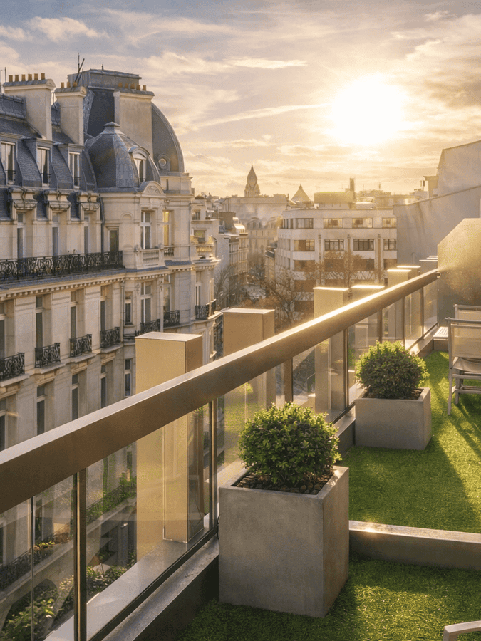 Chairs and planters on a grass balcony by a glass railing in The Champs-Élysées Suite at Warwick Paris Champs Elysées