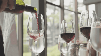 Closeup of pouring wine to glasses at Hotel Mont Gabriel Resort