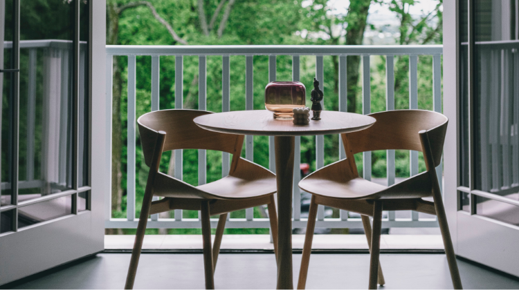 Modern furniture set up on a senic patio overlooking the courtyard