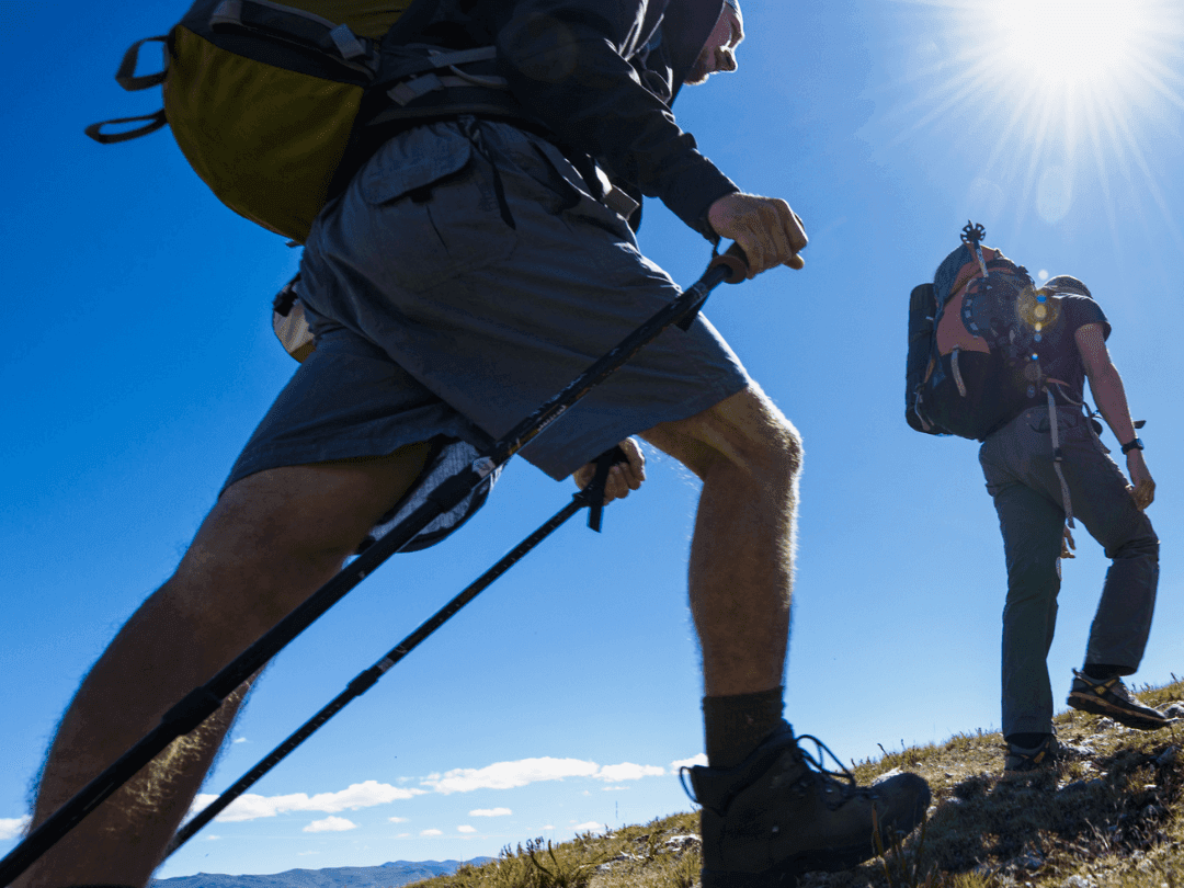 Two hikers with backpacks enjoying the Luxury Adventure hiking special at the NOI Hotel Puma Lodge.