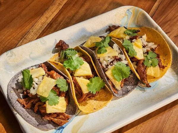 A photo of four tacos