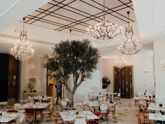 Dining tables arranged in Paparazzi Tuscan Restaurant at Paramount Hotel Midtown