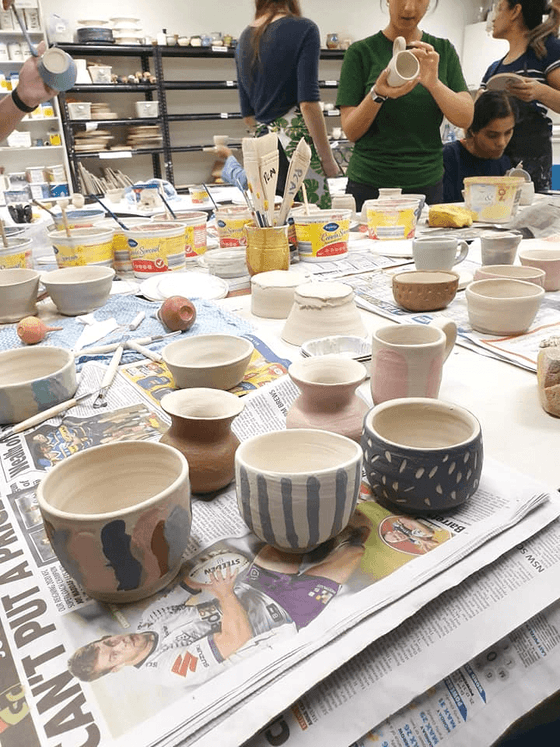 Assorted bowls and cups displayed on a table at Nesuto Parramatta Apartment Hotel