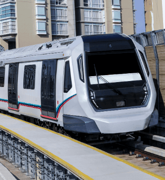 A modern train on an elevated track near Sunway Velocity Hotel