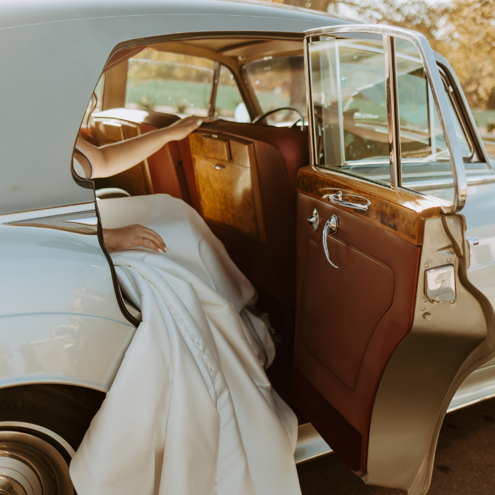 Newly Weds climbing into a car