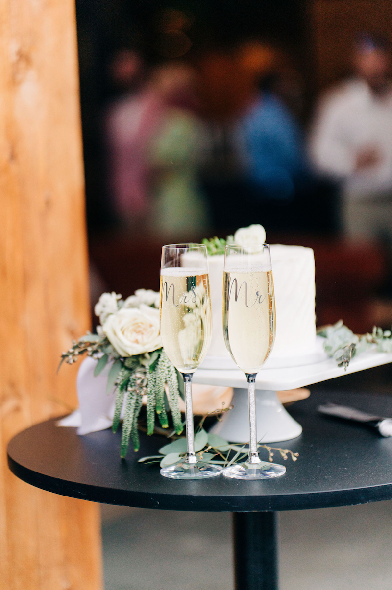 Wedding cake & champagne served at a wedding at Kinship Landing