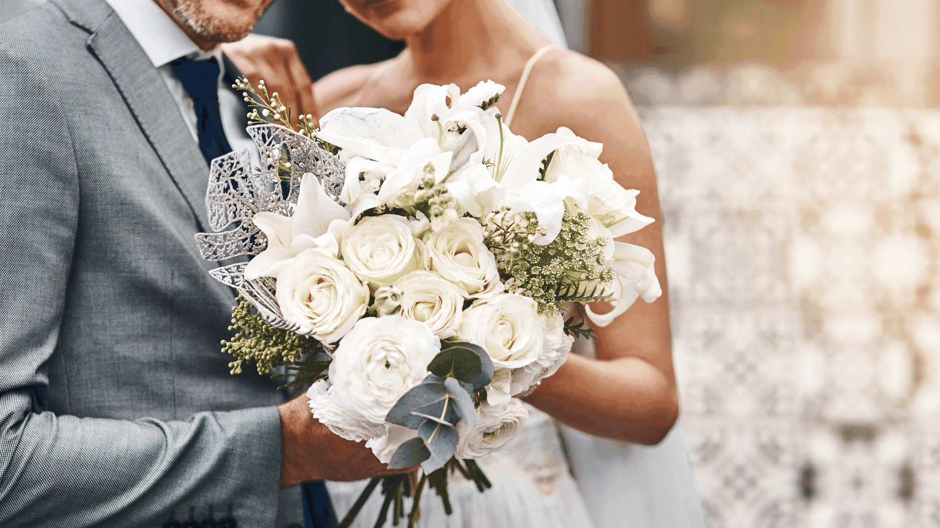 Close-up of couple holding a bouquet at Fiesta Americana