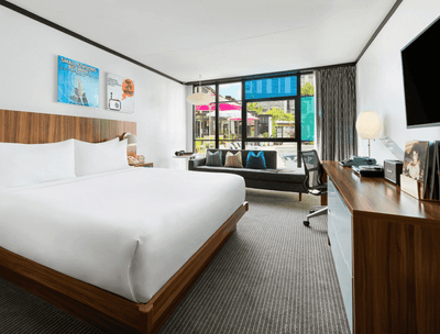 Workspace & couch by the bed in Pool View King at The Verb Hotel