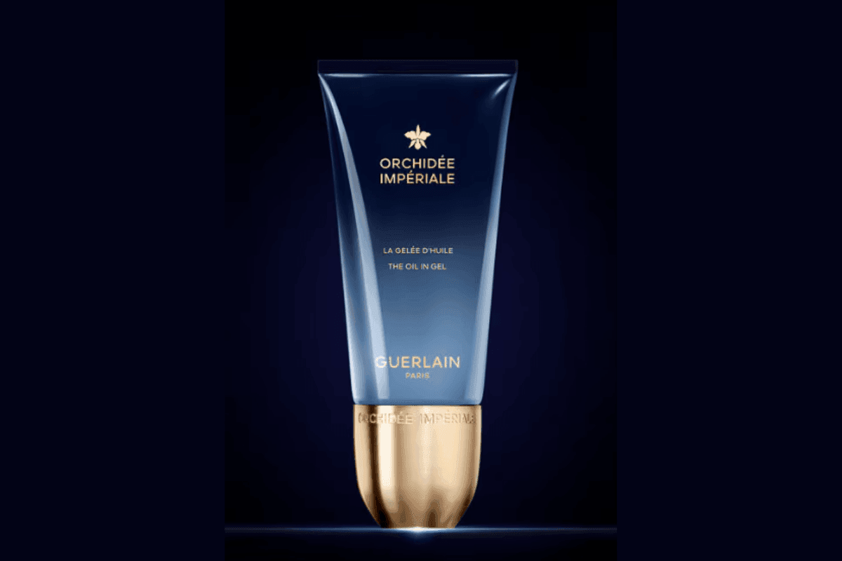 Guerlain Orchidée Impériale Oil in Gel tube with gold base under soft light against a blue backdrop at Hotel X Toronto