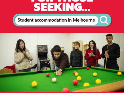 Group of people playing pool in a common room at Student Living - 590 Lygon.