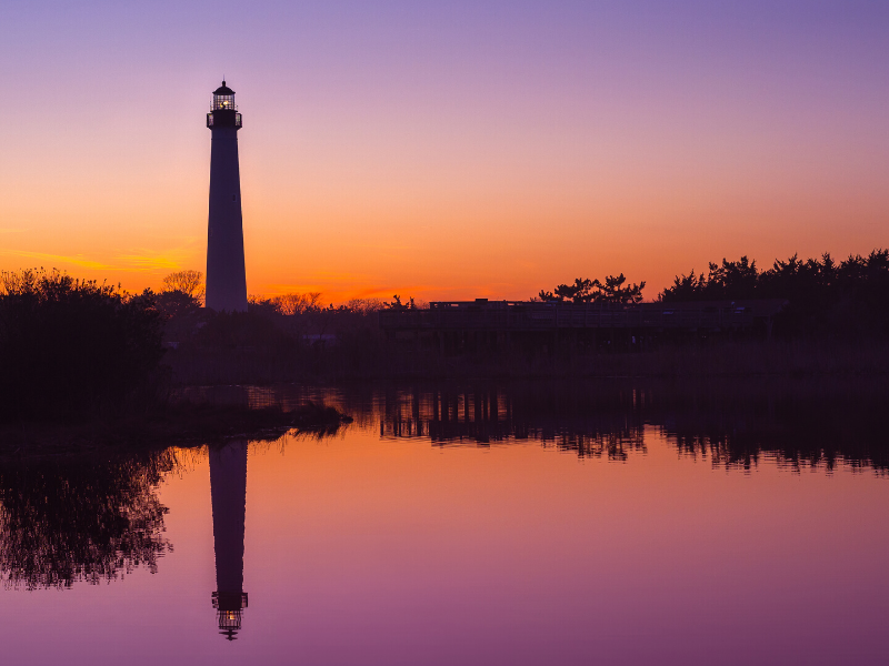 Landscape view of the lighthouse at sunset near ICONA Cape May