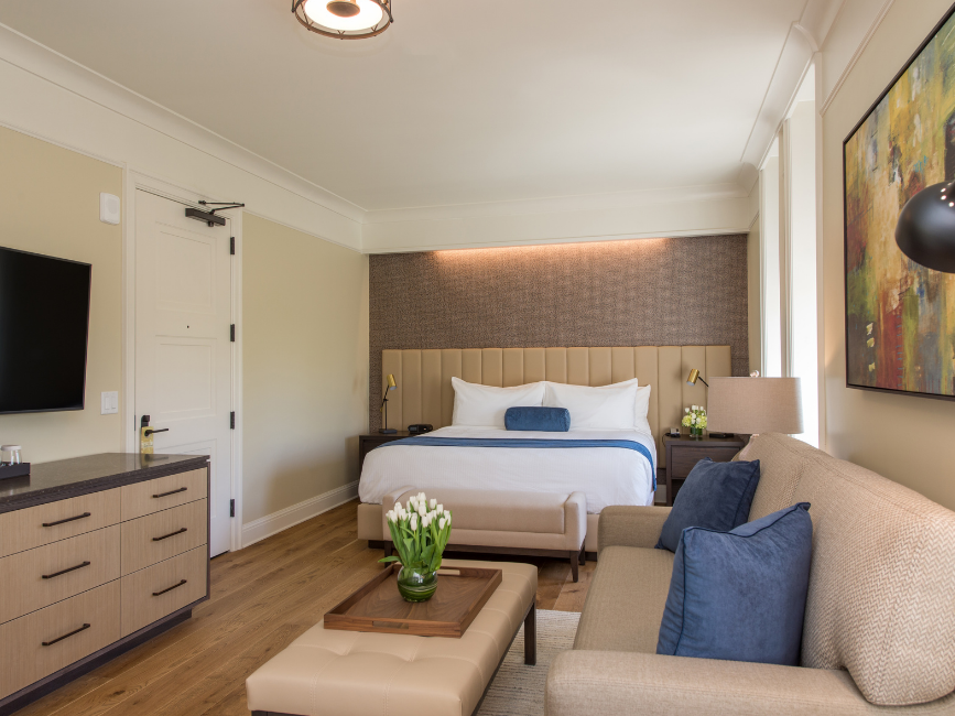 Living & bedroom spaces in Premier King Room at The Abbey Inn & Spa