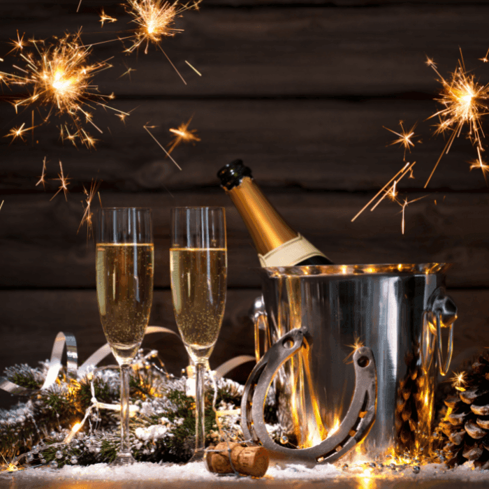 New Year's Eve party at ICONA Diamond Beach image of 2 champage classes, sparklers, and NYE decor