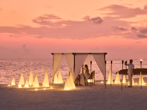 Couple having private dinner on the beach at Grand Park Kodhipparu Maldives