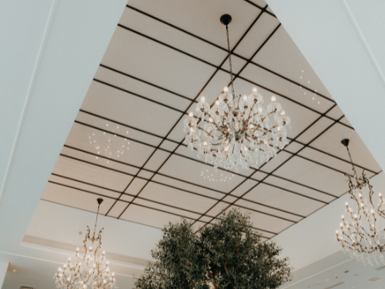 A tree and chandeliers in Paparazzi Tuscan Restaurant at Paramount Hotel Midtown