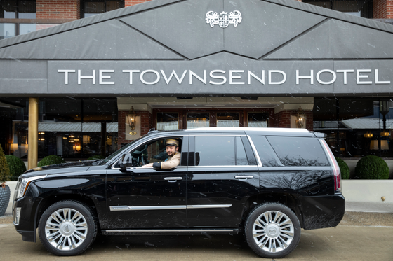A car parked in front of the entrance at The Townsend Hotel