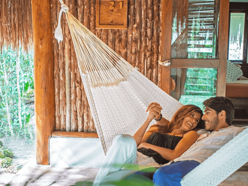 Couple lounging on a hammock at The Explorean Resorts