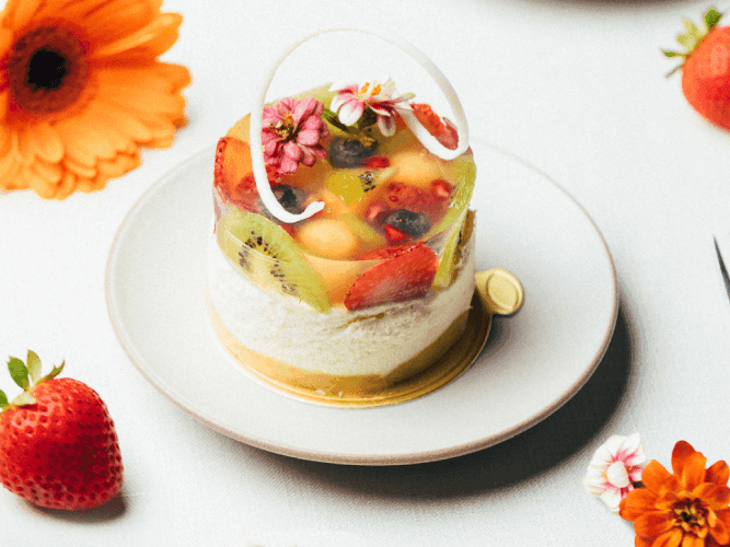 A beautifully presented dessert on a plate, accompanied by a fork and a delicate flower for an elegant touch.