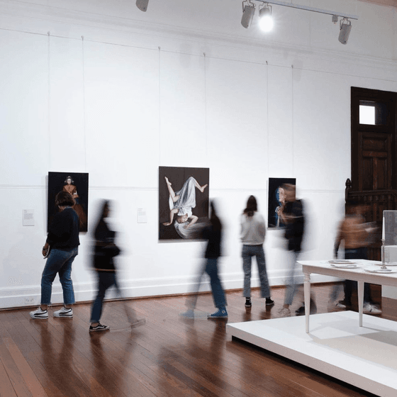 People strolling through the art gallery near Nesuto Mounts Bay