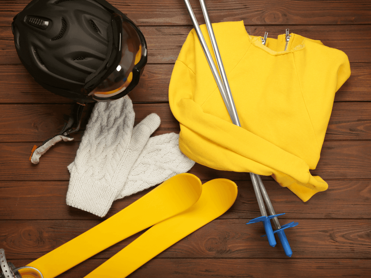 Close-up of ski clothes and items arranged on a wooden table at Blackcomb Springs Suites