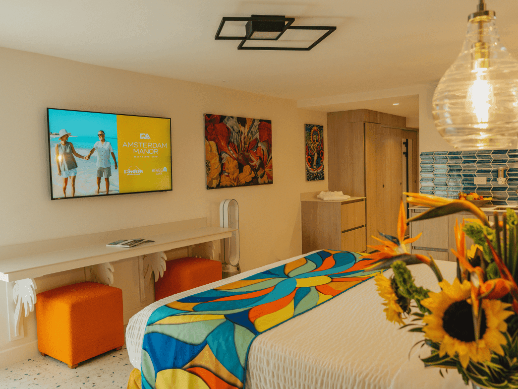 Grand Superior Studio with modern decor and vibrant sunflowers at Amsterdam Manor Beach Resort NEW in Oranjestad.