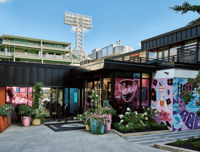 Exterior of The Verb Hotel entrance with colorful graffiti & blooming flowers