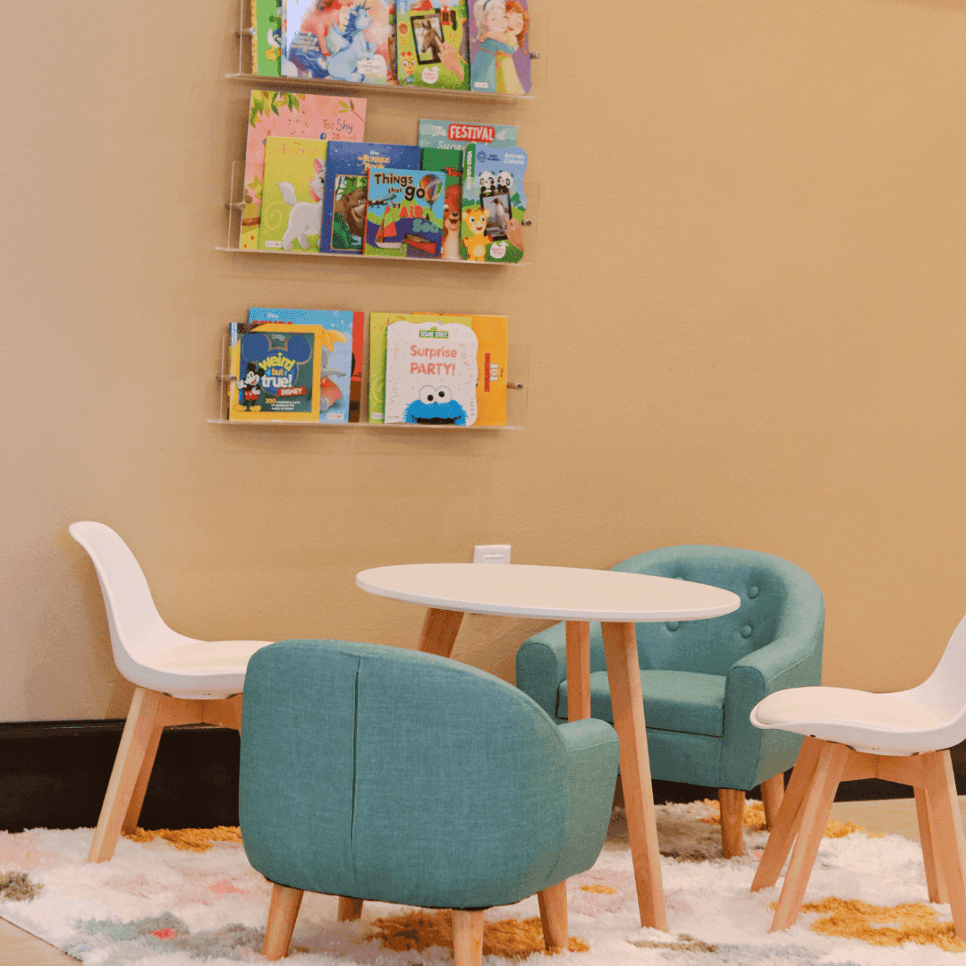 A small seating area with a table and chairs in a lobby or lounge.