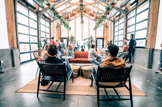 People lounging in the Green Haus at Kinship Landing