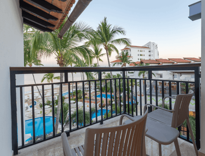 Balcony area with two chairs and table in Honeymoon Suite Ocean View at Buenaventura Grand Hotel and Spa