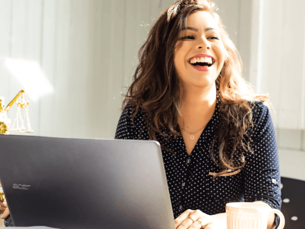 Smiling girl using laptop at Hotel Mont Gabriel Resort & Spa