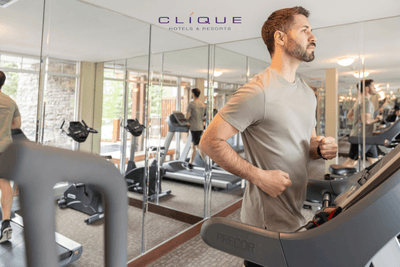 Guests work out in the bright fitness center at the Falcon Crest Lodge