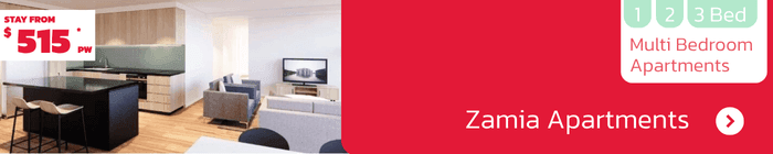 Spacious living area at Zamia Apartments featuring kitchen, lounge and study space – 1-3 bedroom apartments from $515 per week.