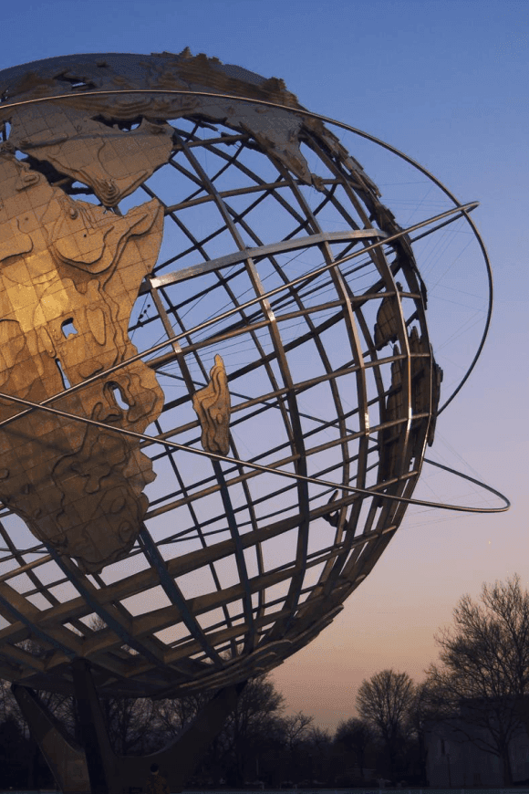 Unisphere globe sculpture at dusk with soft sky tones near The Rhyland Hotel in Flushing NY, creating a memorable landmark